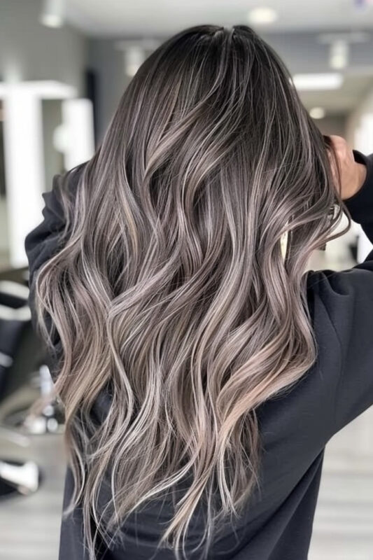 A woman with grey brown hair color, a cool-toned mix of brown and grey.