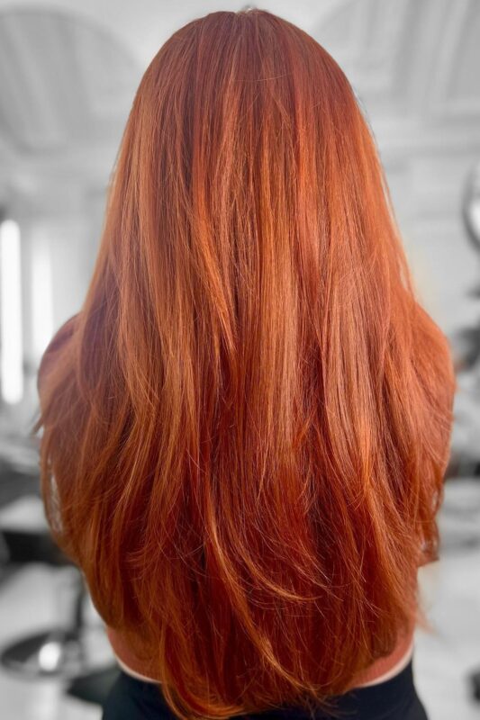 Woman with a burnt orange copper hair color.