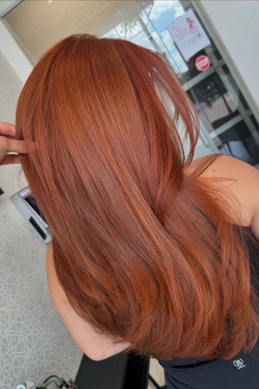Woman with a copper orange hair color.