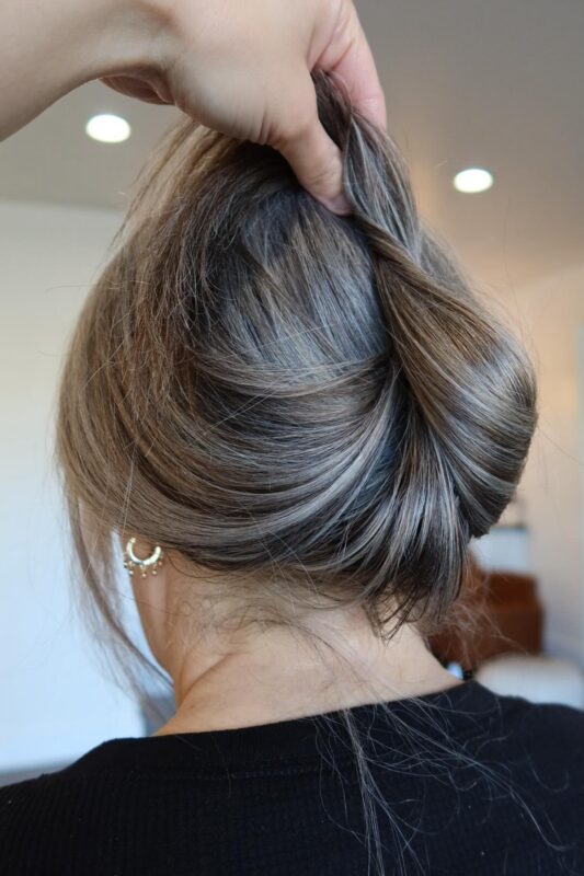 Blended grey hair color enhanced with silvery white highlights.