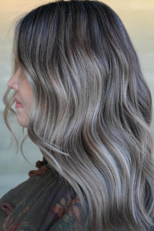 Cool ash and silver highlights for gray blending on dark hair.