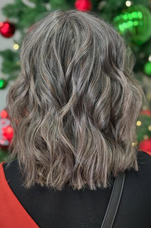 Brunette hair with honey and caramel balayage highlights for gray blending.