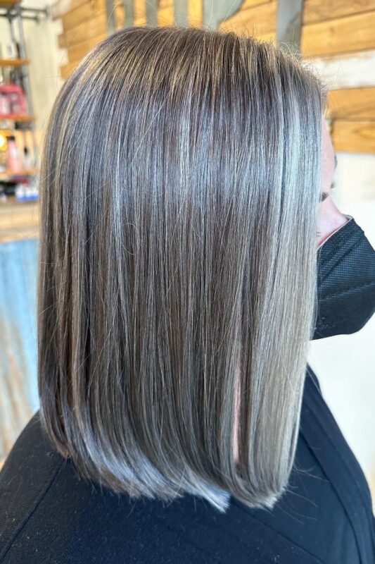 Brunette hair with silvery white herringbone highlights and lowlights for grey blending.