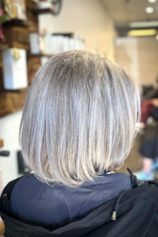 Subtle silver and white highlights for growing out gray hair.