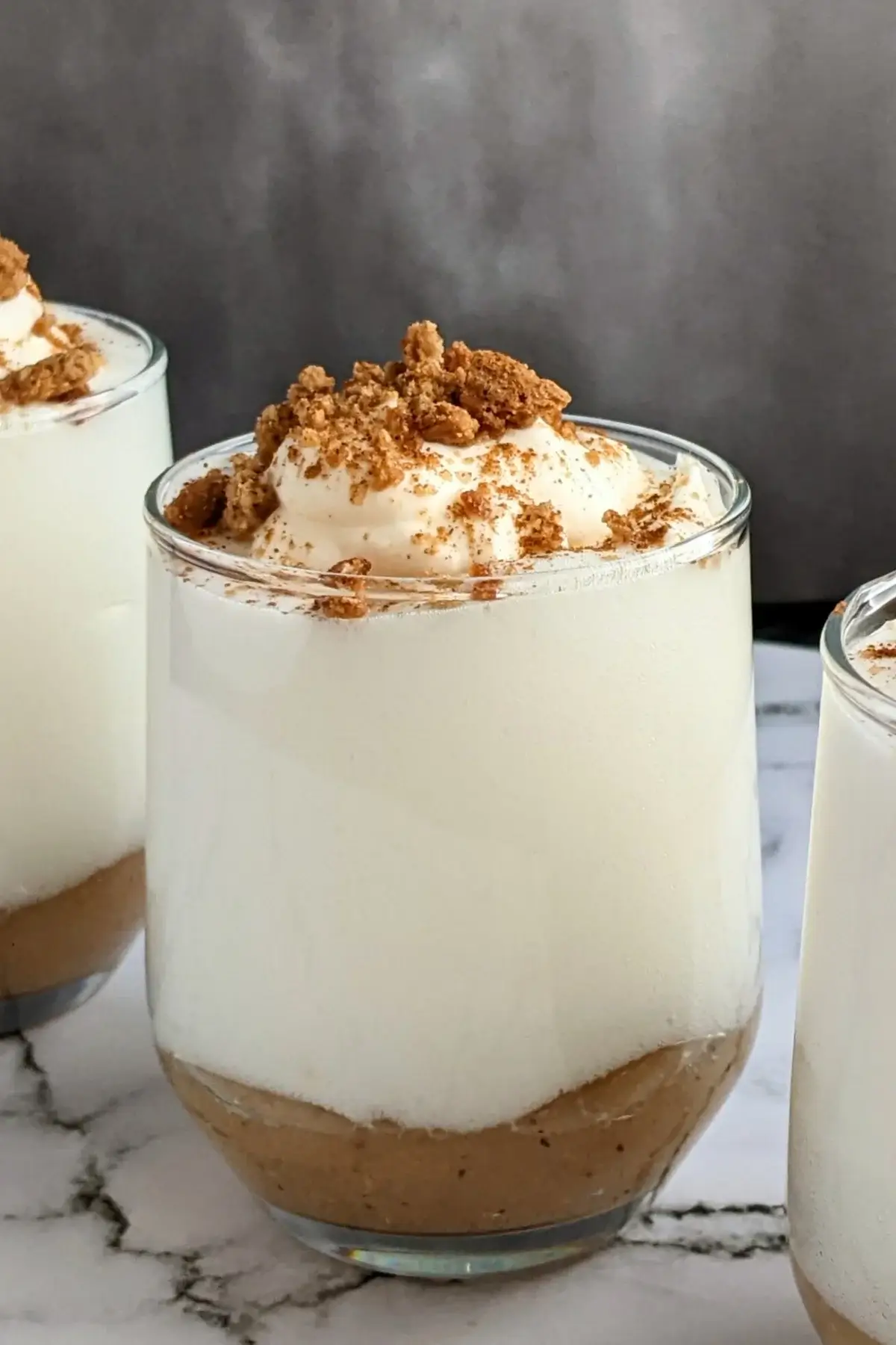 Fluffy apple mousse dessert with smooth, airy whipped egg whites on a bed of homemade apple sauce.