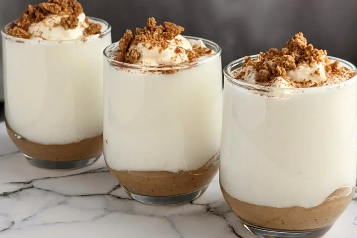 Fluffy apple mousse dessert with smooth, airy whipped egg whites on a bed of homemade apple sauce.