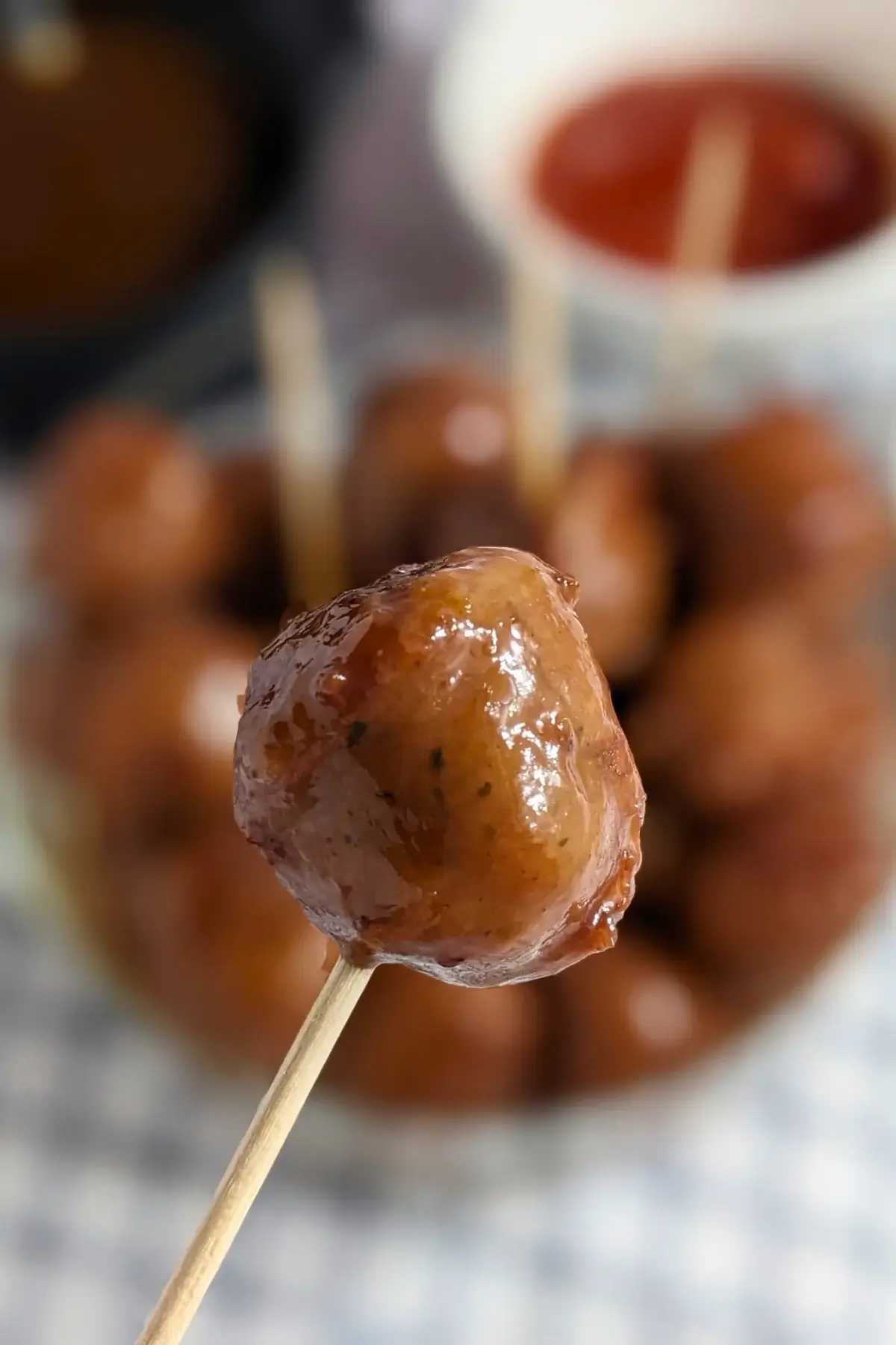 Cranberry Sausage Bites - sticky sausage appetizers made with pieces of fresh sausages, baked in the oven in a cranberry, sweet chili, soy sauce, and lime marinade.