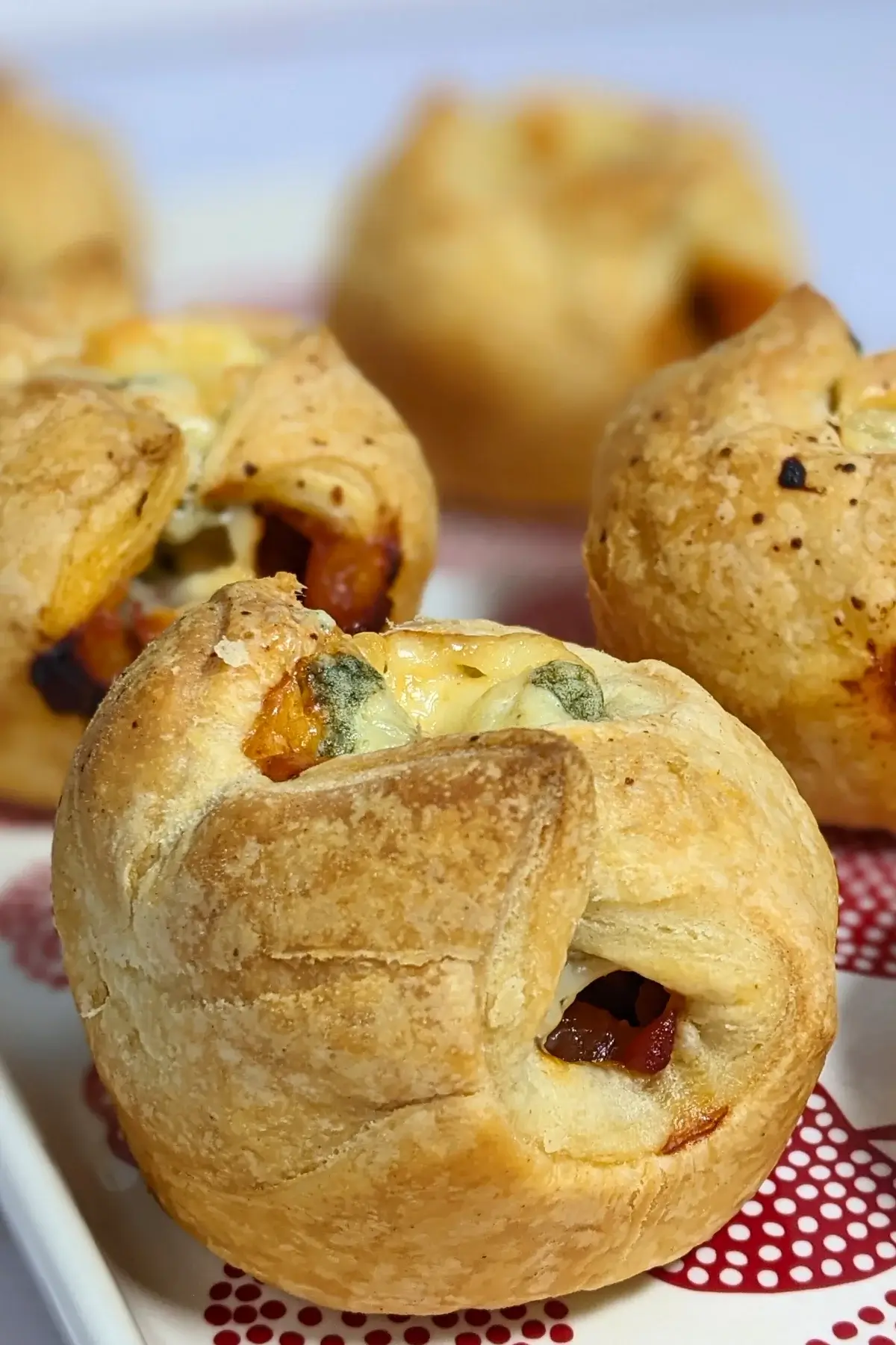 Prosciutto and blue cheese puff pastry appetizers - savory puff pastry cups filled with sweet chili sauce, prosciutto and blue cheese.