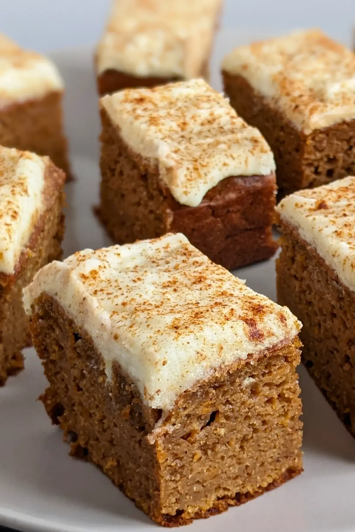 Pumpkin bars made with applesauce and topped with light, sugar-free frosting.