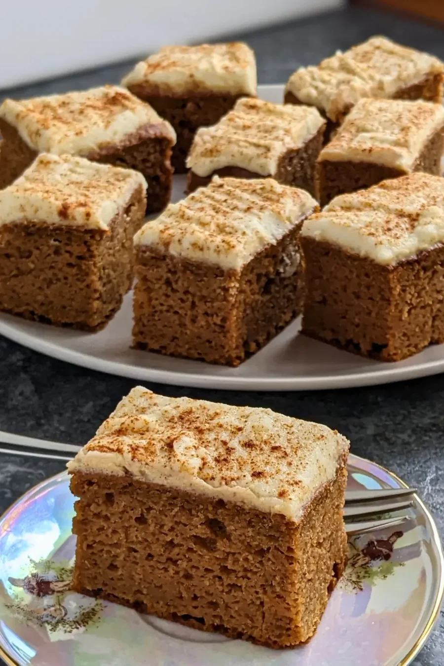 Pumpkin bars made with applesauce and topped with light, sugar-free frosting.