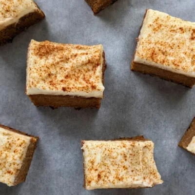 Pumpkin bars made with applesauce and topped with light, sugar-free frosting.