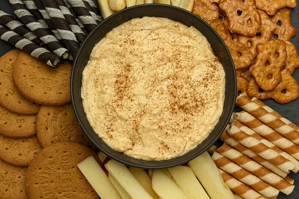 Pumpkin dip with cream cheese, cinnamon, pumpkin pie spice and Greek yogurt served with sliced apples and pears, vanilla wafer sticks, biscuits, and pretzels.