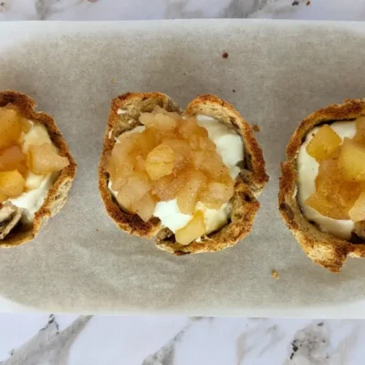 Ricotta and homemade apple sauce dessert toast cups - Muffin tin toasted bread cups with creamy ricotta filling and a generous spoonful of spiced homemade apple sauce.