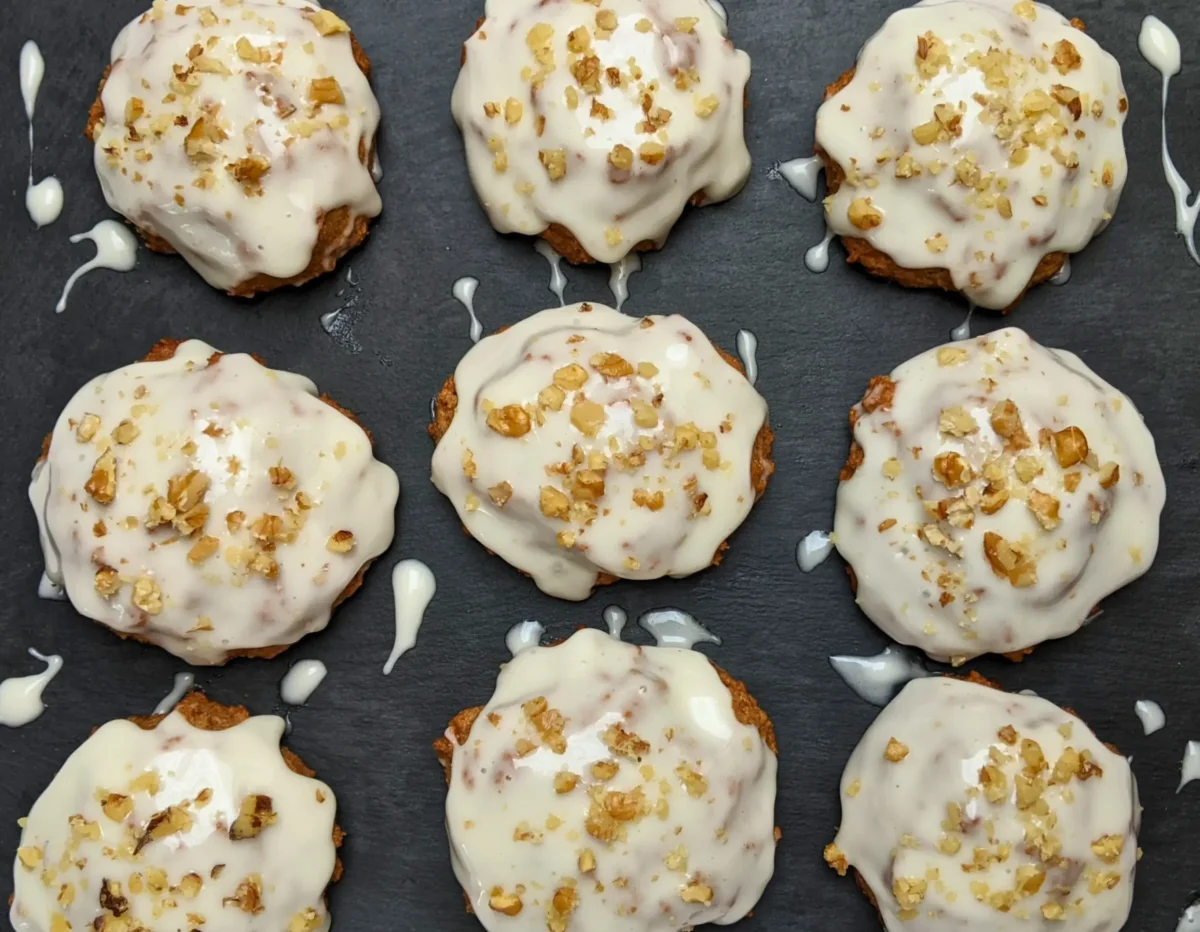 Applesauce cookies with cream cheese frosting - healthier fall cookies made with applesauce, wholemeal flour, and a mix of white and coconut sugar, topped with a cream cheese frosting and crushed walnuts.