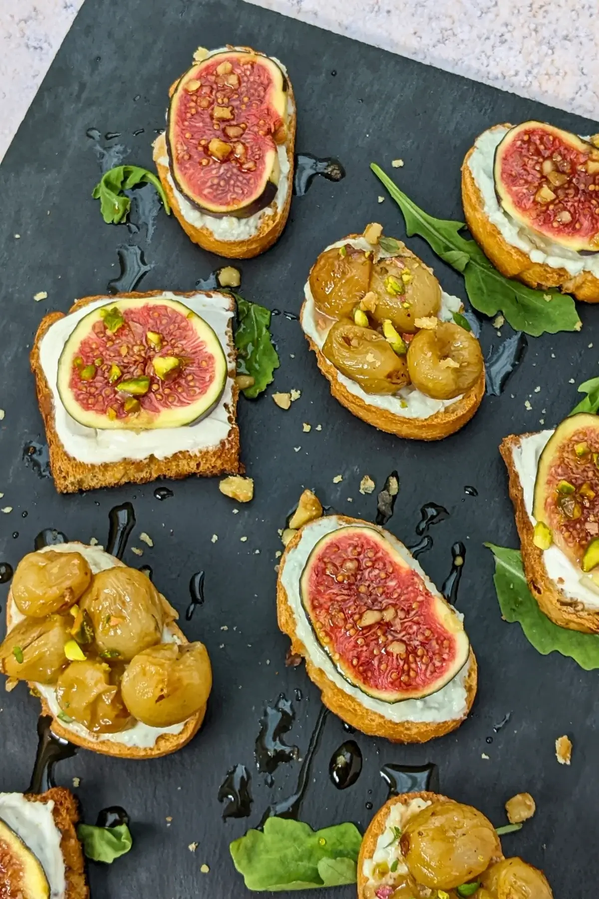 Cheese and Fruits Crostini Appetizers Platter - Italian crostini party food platter with cheese and fruit toppings.