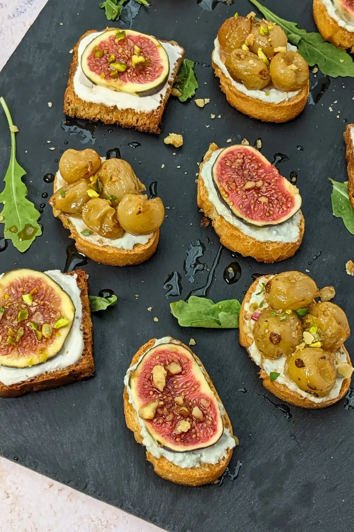 Cheese and Fruits Crostini Appetizers Platter - Italian crostini party food platter with cheese and fruit toppings.