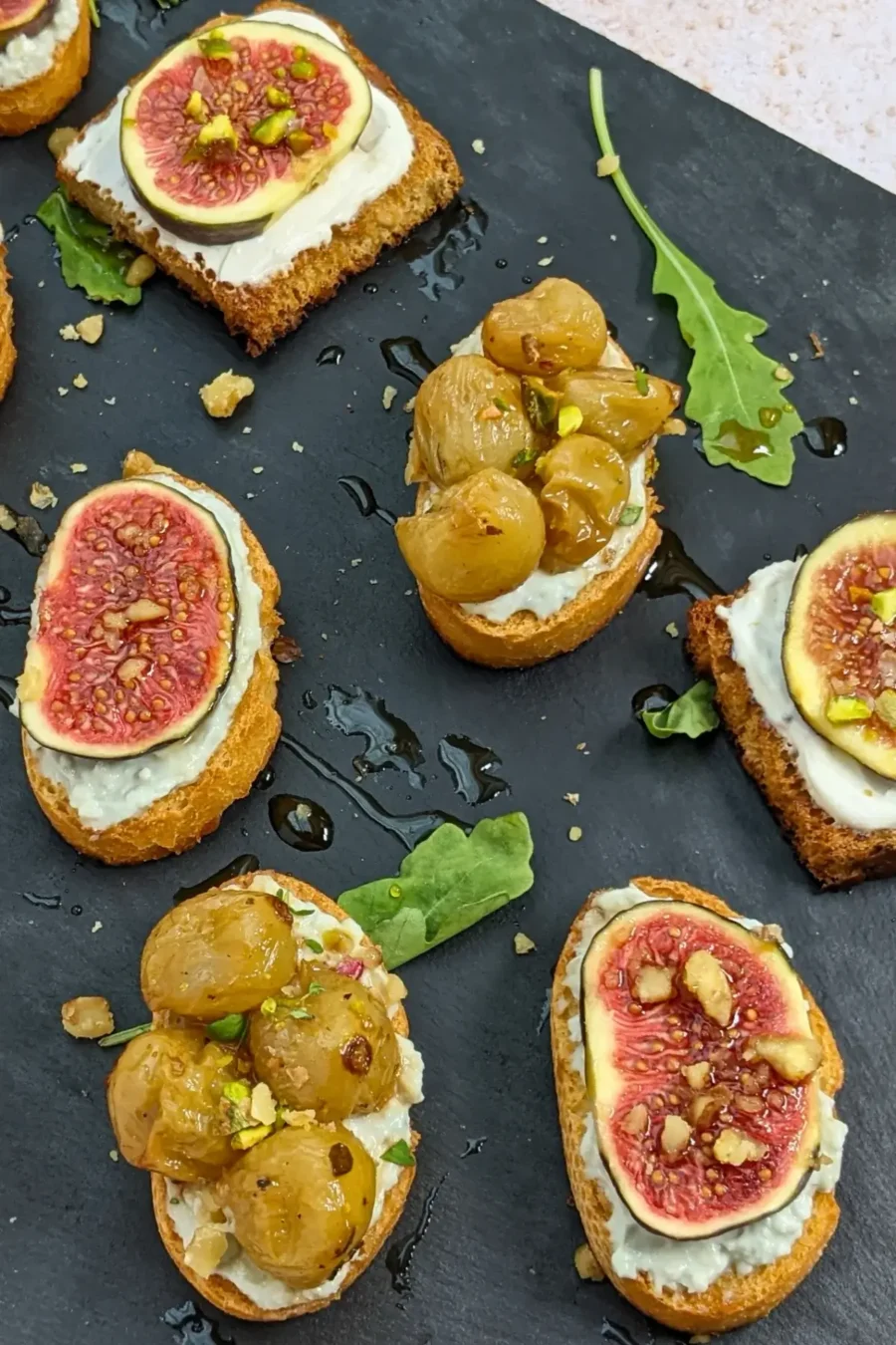 Cheese and Fruits Crostini Appetizers Platter - Italian crostini party food platter with cheese and fruit toppings.