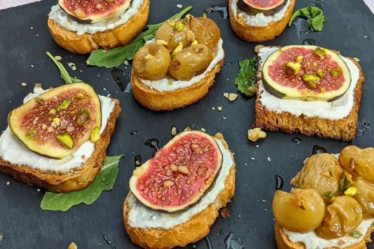 Cheese and Fruits Crostini Appetizers Platter - Italian crostini party food platter with cheese and fruit toppings.