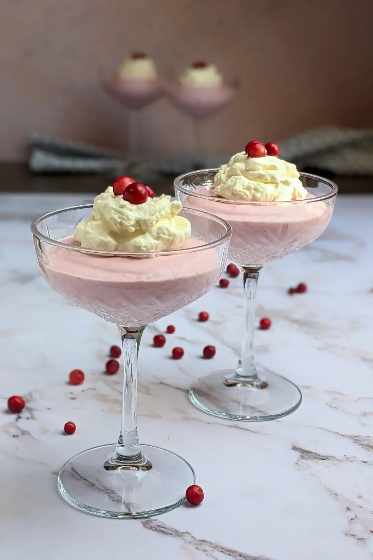 Cranberry mousse dessert - a mousse dessert made with cranberries and whipped egg whites and heavy cream, served in individual glasses.