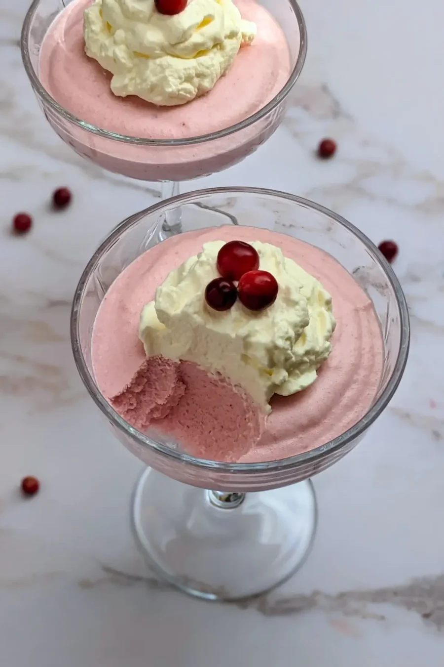 Cranberry mousse dessert - a mousse dessert made with cranberries and whipped egg whites and heavy cream, served in individual glasses.