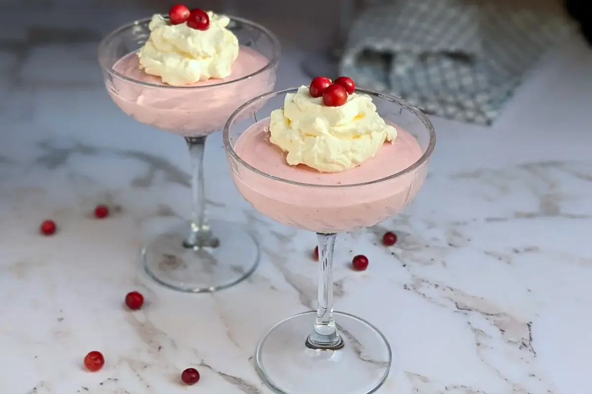 Cranberry mousse dessert - a mousse dessert made with cranberries and whipped egg whites and heavy cream, served in individual glasses.