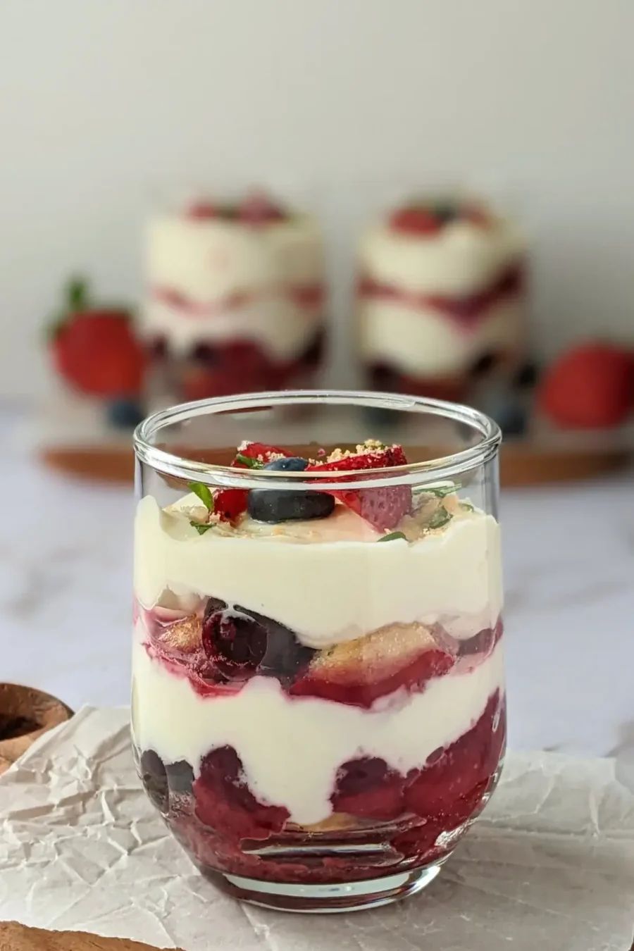 Healthier take on tiramisu made with mascarpone, Greek yogurt, ladyfingers, and a sweet mixed berry compote.