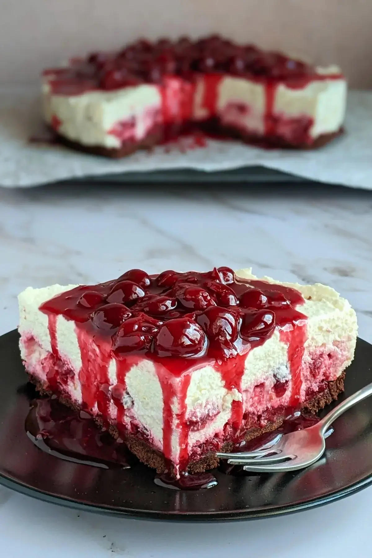 No Bake Cheesecake With Cherry Topping - easy no bake cheesecake on a chocolate cookie crumb base, made with fluffy whipped cream and cottage cheese, and topped with homemade cherry compote.