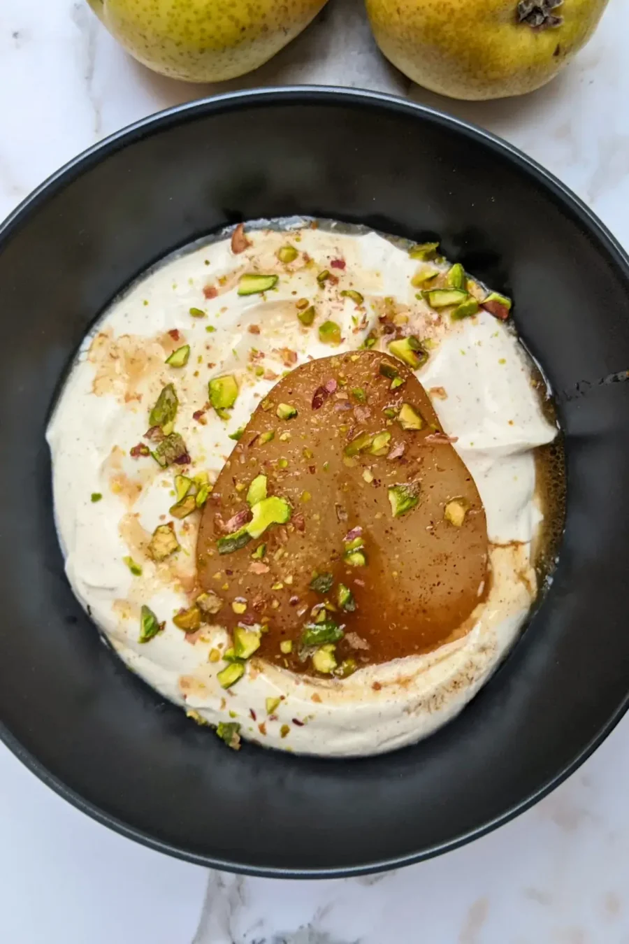 Poached pears with mascarpone cream - a dessert with cinnamon and pumpkin spiced oven-roasted pears served with a fluffy mascarpone and Greek yogurt cream.