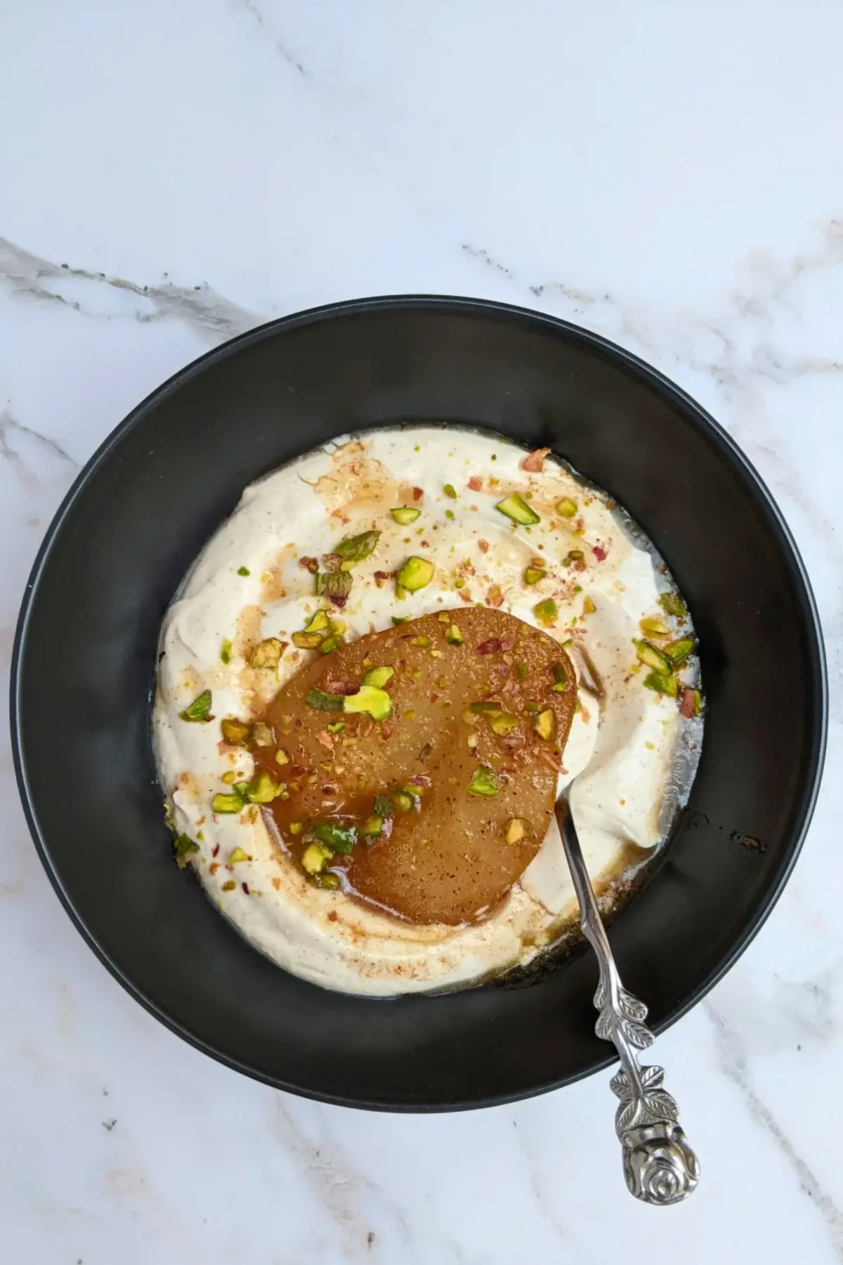 Poached pears with mascarpone cream - a dessert with cinnamon and pumpkin spiced oven-roasted pears served with a fluffy mascarpone and Greek yogurt cream.