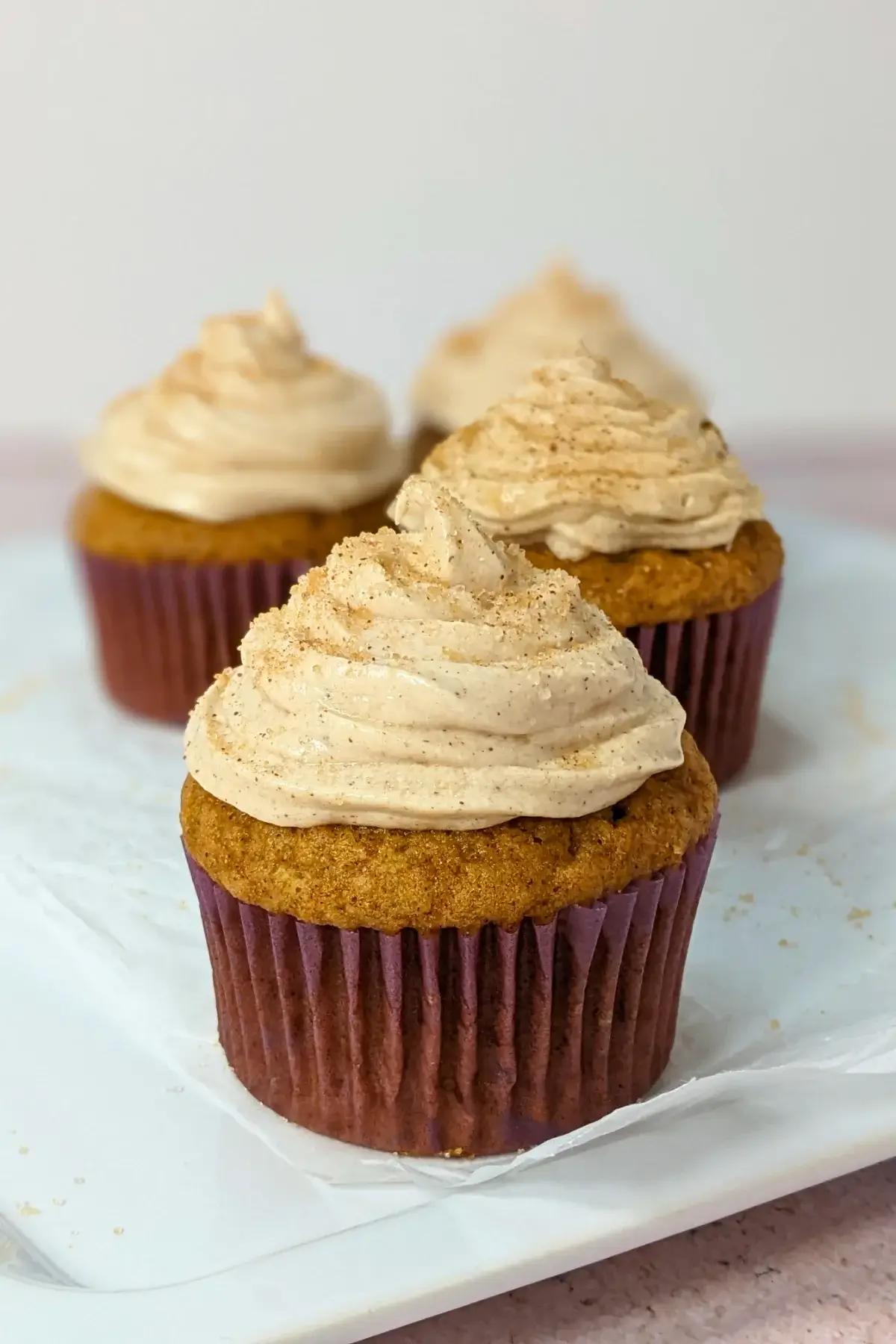 Pumpkin Cheesecake Cupcakes with Cinnamon Cream Cheese Icing - pumpkin cupcakes with a cheesecake filling and cinnamon cream cheese frosting.