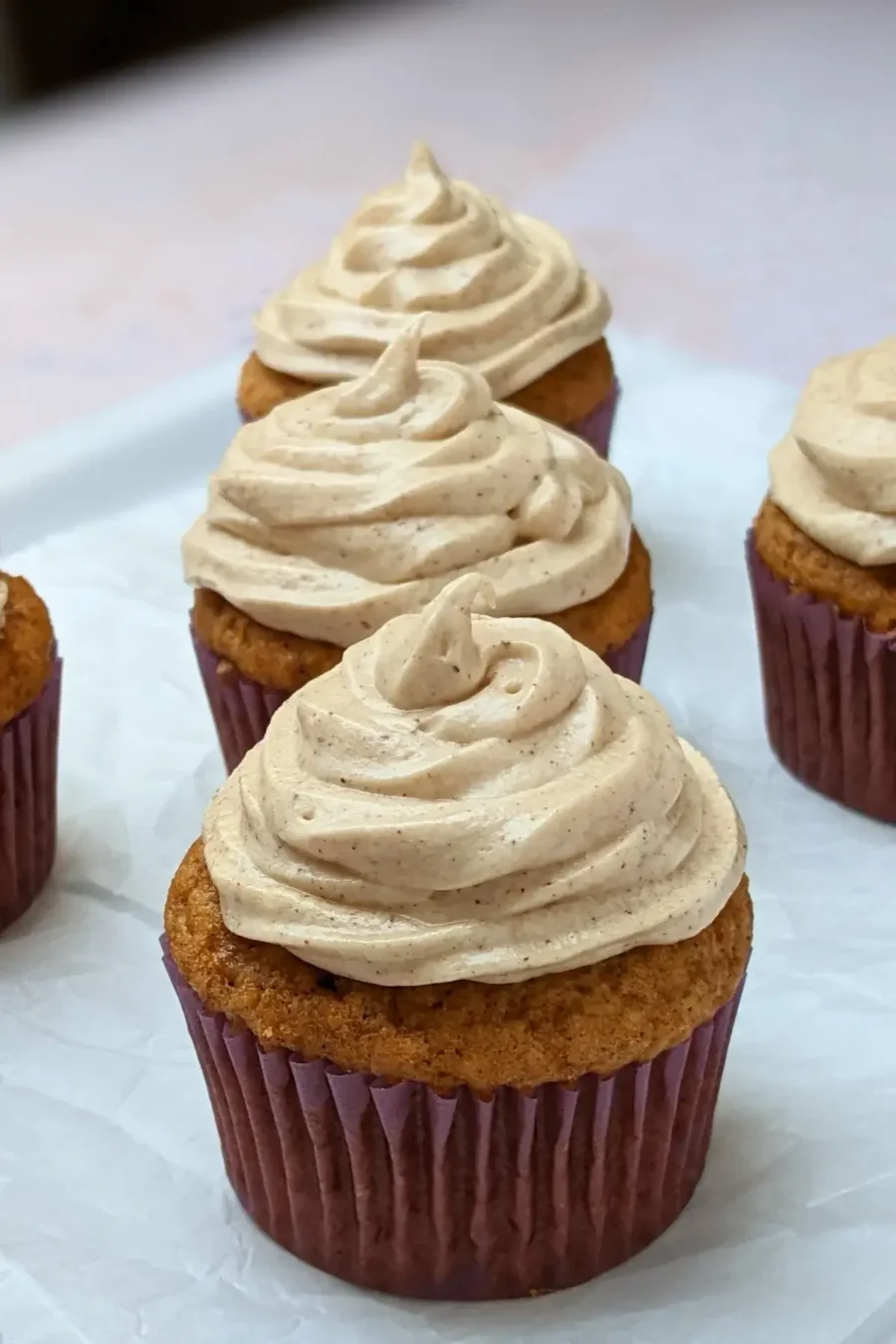 Pumpkin Cheesecake Cupcakes with Cinnamon Cream Cheese Icing - pumpkin cupcakes with a cheesecake filling and cinnamon cream cheese frosting.