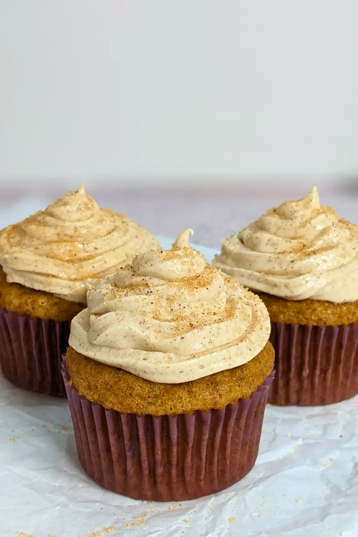 Pumpkin Cheesecake Cupcakes with Cinnamon Cream Cheese Icing - pumpkin cupcakes with a cheesecake filling and cinnamon cream cheese frosting.