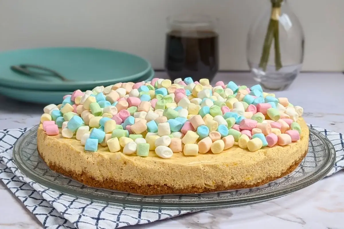 Pumpkin marshmallow cake - a fluffy no-bake cake with an oat cookie crust, pumpkin marshmallow cheesecake filling, and whole marshmallows for decoration.