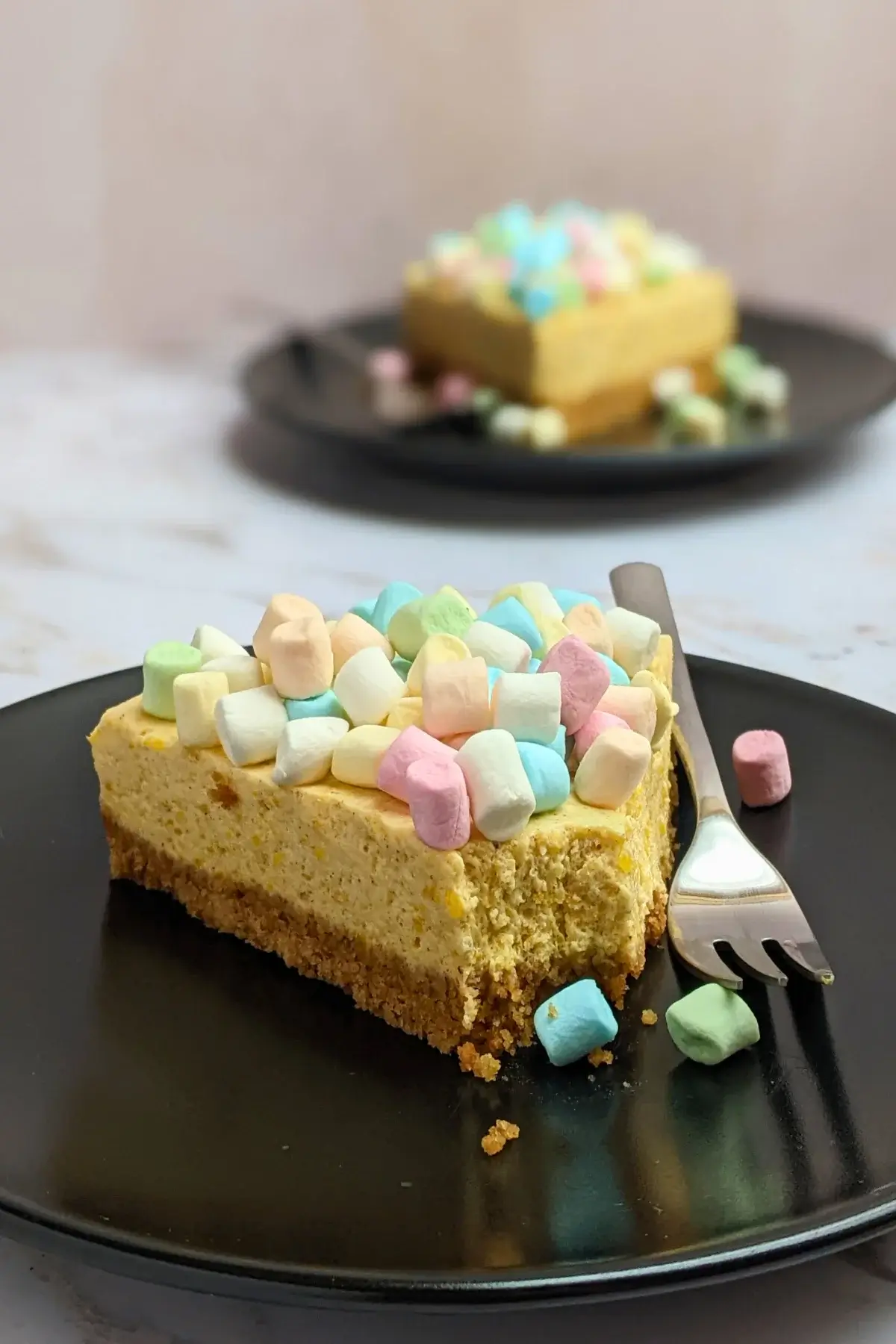 Pumpkin marshmallow cake - a fluffy no-bake cake with an oat cookie crust, pumpkin marshmallow cheesecake filling, and whole marshmallows for decoration.