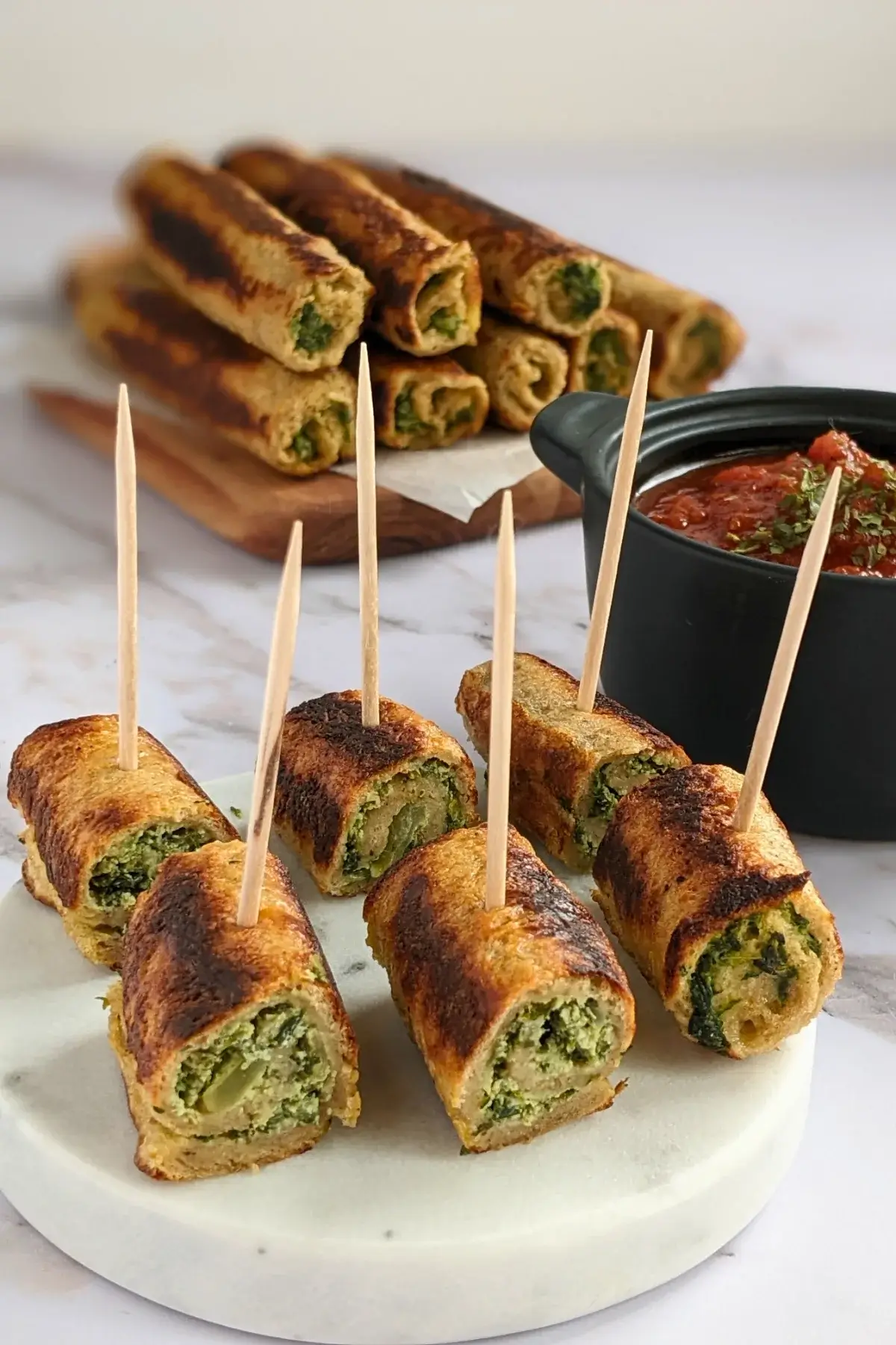 Italian-style savory stuffed French toast appetizers with a garlicky spinach and ricotta mix served with marinara sauce.