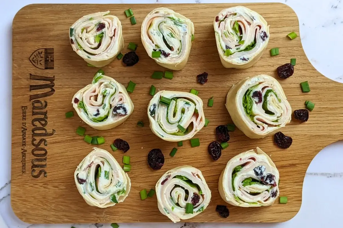 Turkey Pinwheels With Dried Cranberries - tortilla pinwheels with cream cheese filling, dried cranberries, turkey ham, and a bit of salad for color.