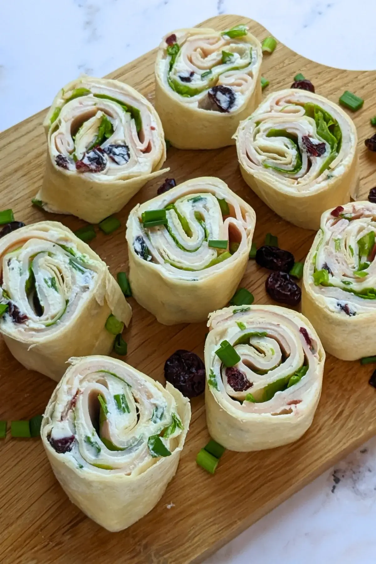 Turkey Pinwheels With Dried Cranberries - tortilla pinwheels with cream cheese filling, dried cranberries, turkey ham, and a bit of salad for color.
