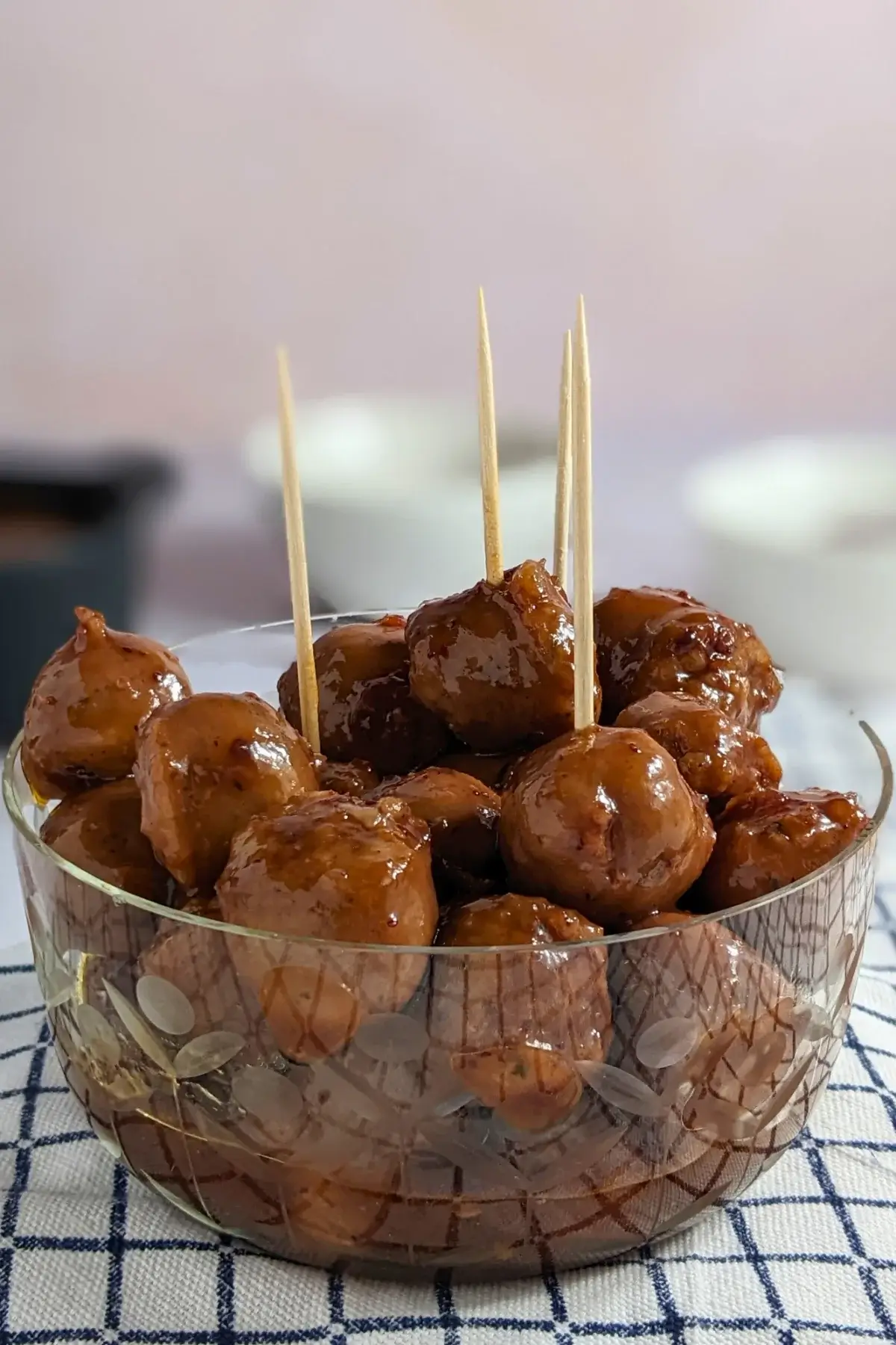 Cranberry Sausage Bites - sticky sausage appetizers made with pieces of fresh sausages, baked in the oven in a cranberry, sweet chili, soy sauce, and lime marinade.