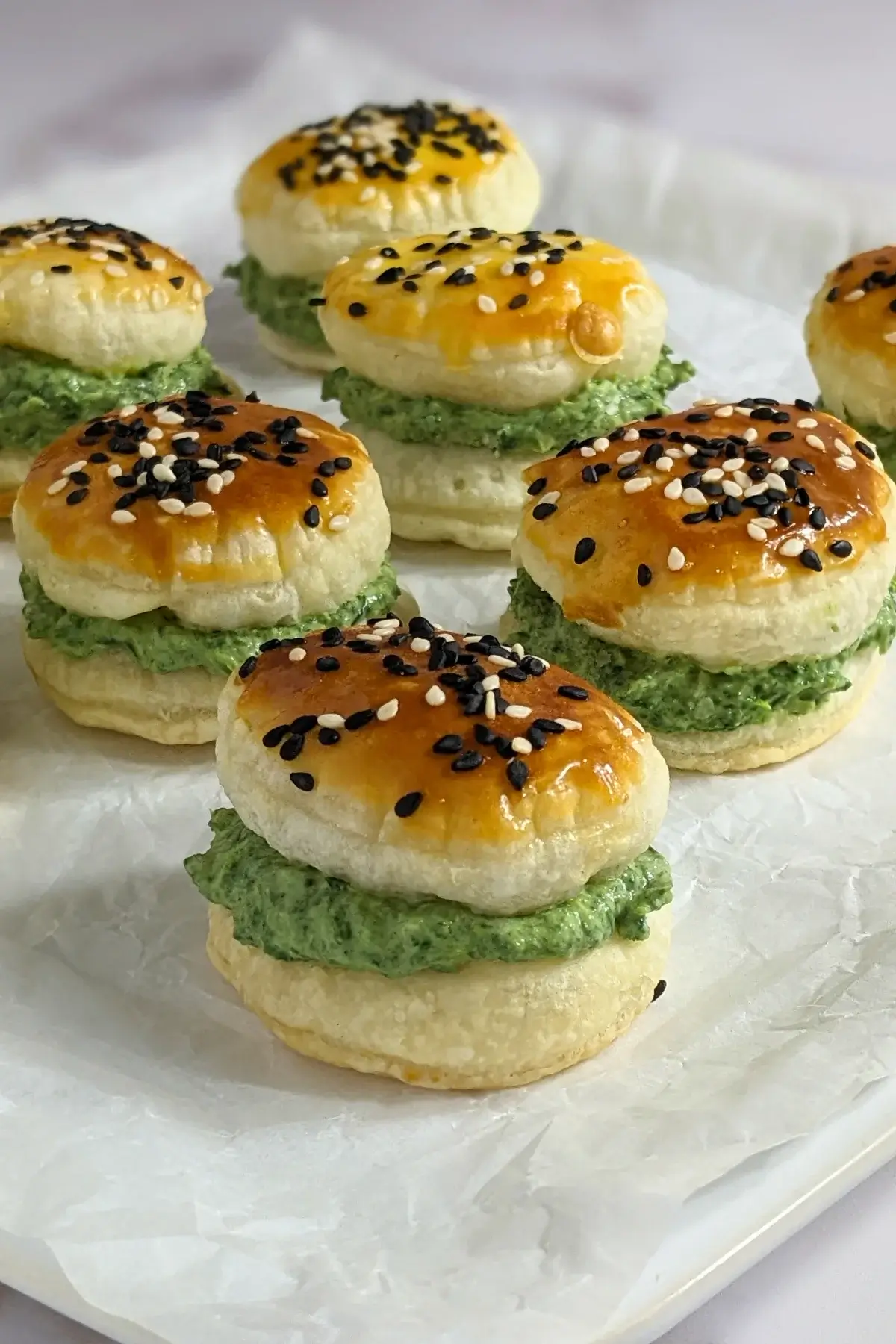 Goat Cheese Spinach Puffs - puff pastry appetizers made with a goat cheese-spinach filling, sandwiched between homemade puff pastry shells. These look really festive with the green color!