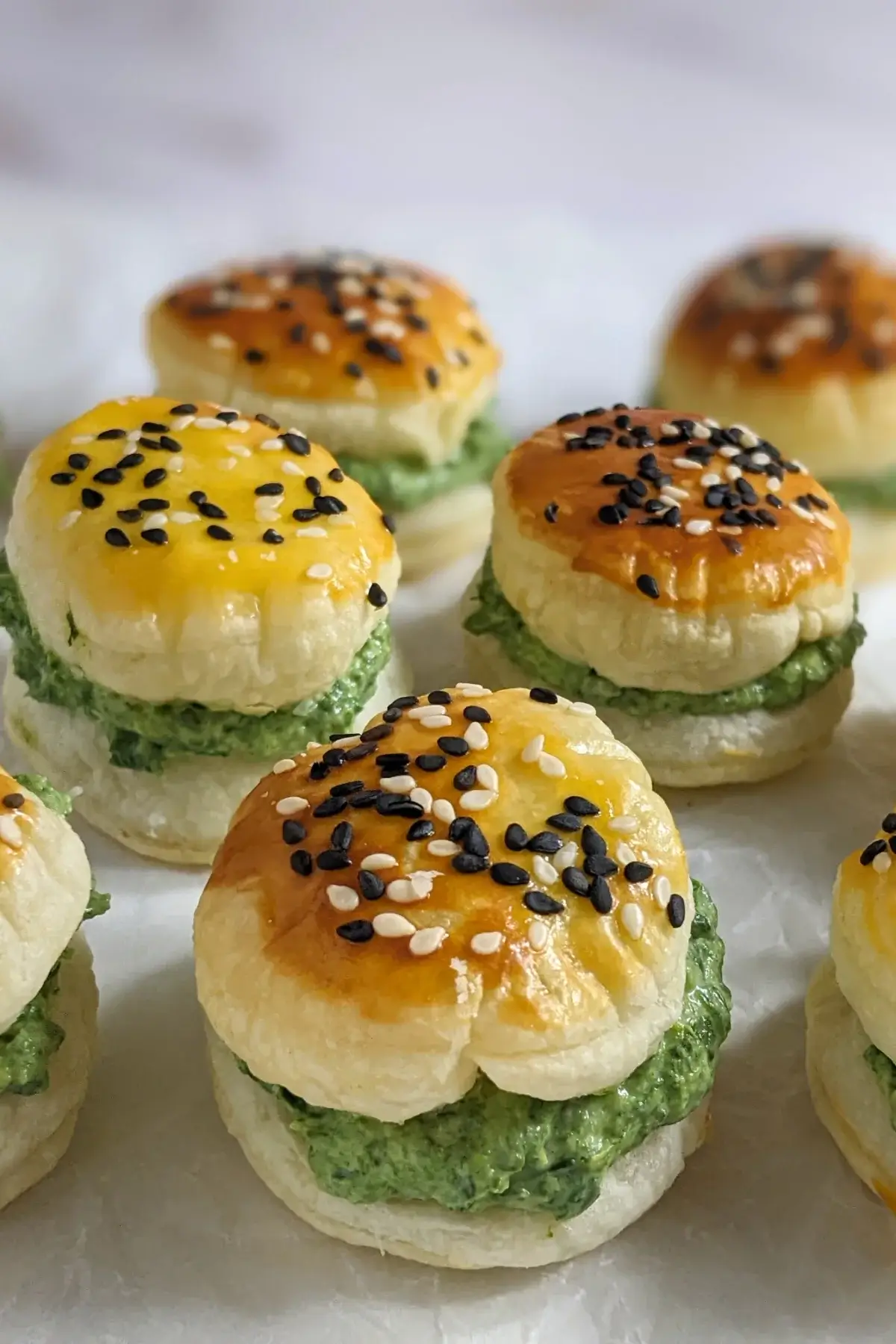 Goat Cheese Spinach Puffs - puff pastry appetizers made with a goat cheese-spinach filling, sandwiched between homemade puff pastry shells. These look really festive with the green color!