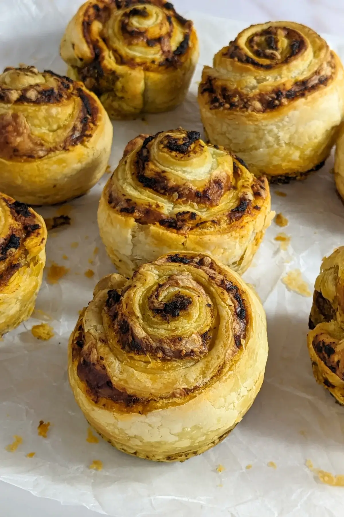 Pesto, Tomato Sauce, and Cheese Puff Pastry Rolls - puff pastry appetizers made with fresh puff pastry, pesto, tomato sauce, and grated cheese, rolled up and baked in a muffin tin.