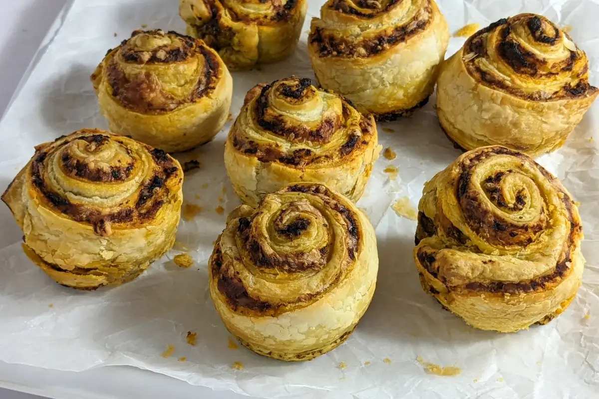 Pesto, Tomato Sauce, and Cheese Puff Pastry Rolls - puff pastry appetizers made with fresh puff pastry, pesto, tomato sauce, and grated cheese, rolled up and baked in a muffin tin.