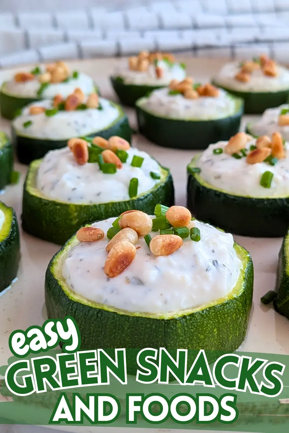 Baked Zucchini Rounds Appetizers With Goat Cheese - oven-baked zucchini rounds topped with a creamy goat cheese-Greek yogurt spread, toasted pine nuts, and fresh chives