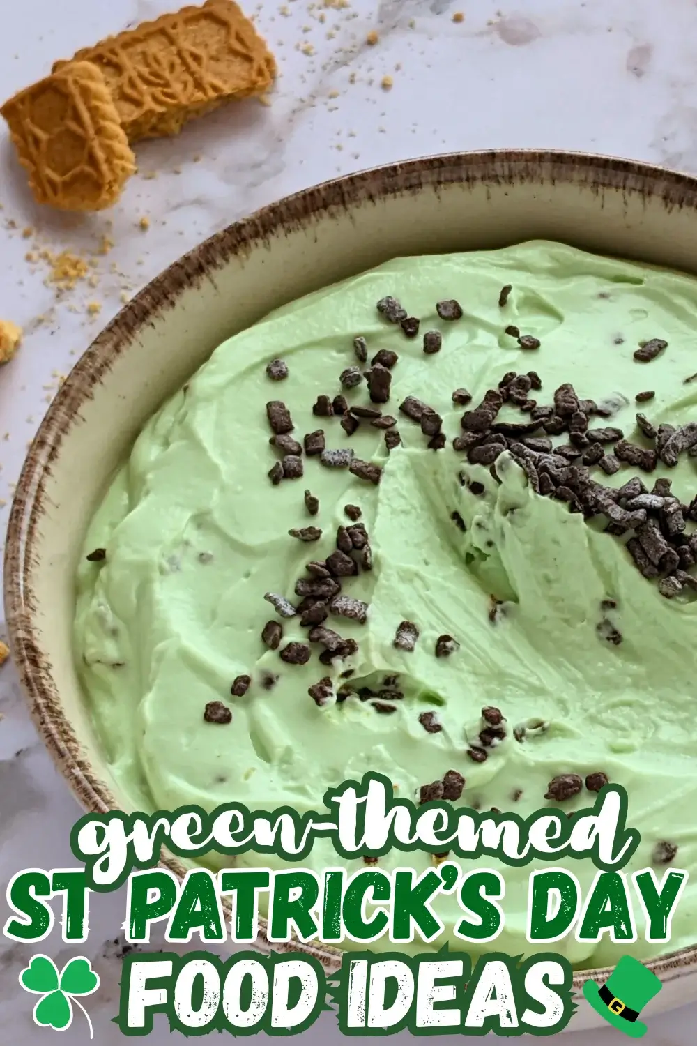 Fluffy Green-Themed Cheesecake Dessert Dip - fluffy cheesecake dip dessert made with cream cheese, heavy whipping cream, Greek yogurt, a few drops of green food coloring, and dark chocolate chips.
