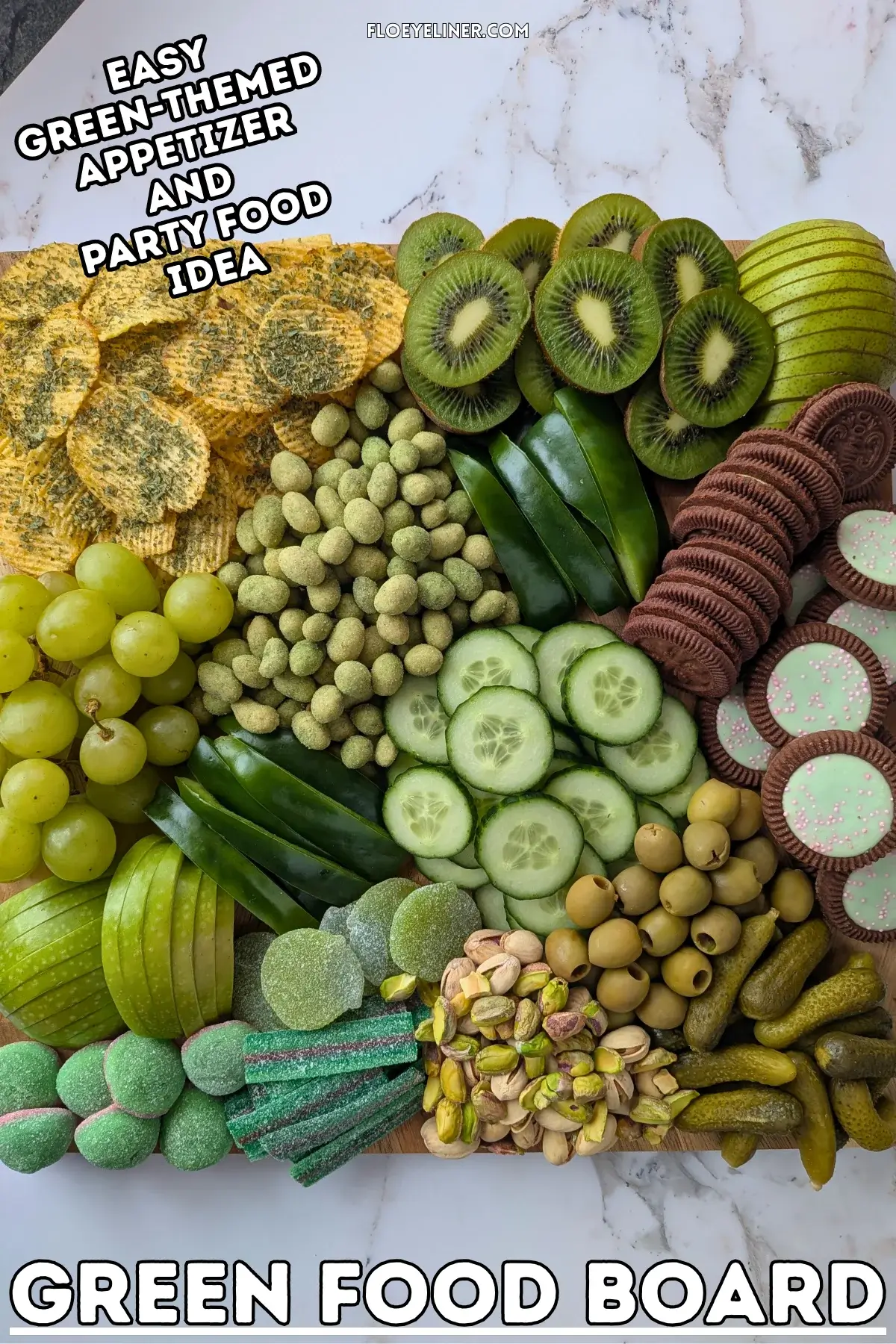 Green Food Board - Green themed party food board and snack tray with homemade tzatziki sauce and simple avocado dip; dried chives covered potato chips; crunchy wasabi coated peanuts; fresh cucumber and green bell peppers; mini pickles; pistachios; olives in brine; fresh fruit like green grapes, green apples, kiwis, and green pears; and a selection of sweet snacks like green gummy candies and Domino's lime and peppermint cookies.