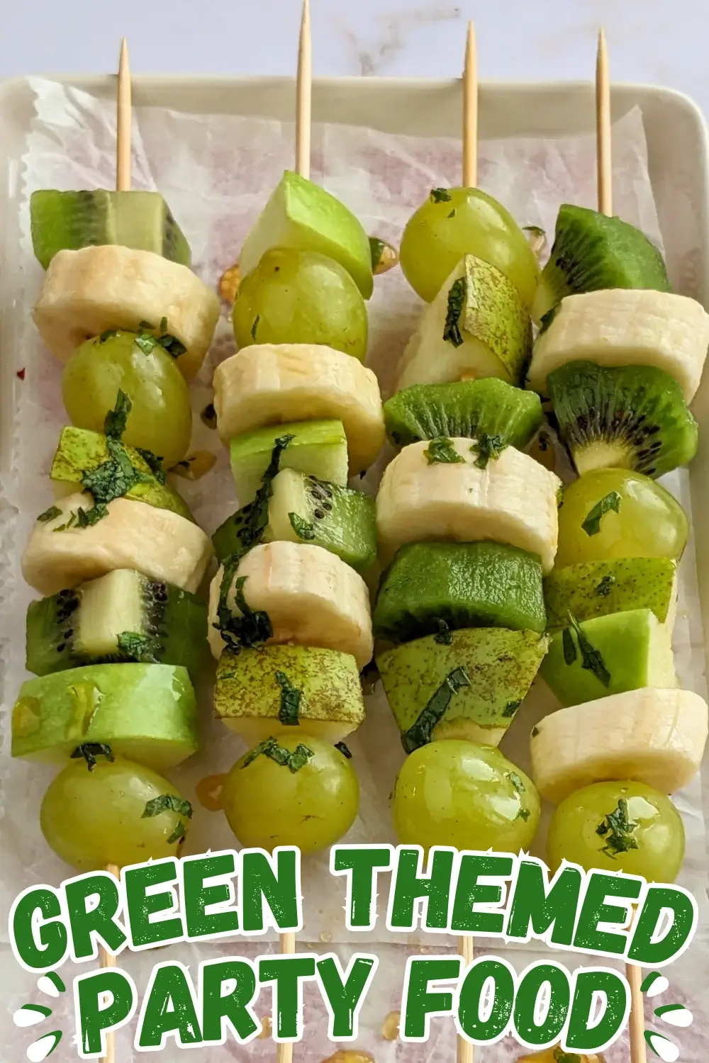 Green Fruit Kabobs - fruit skewers made with chunks of green fruits like kiwi, grapes, green apple, and green pear, plus chunks of bananas, drizzled with a fresh mint, lime juice, and maple sryup sauce.