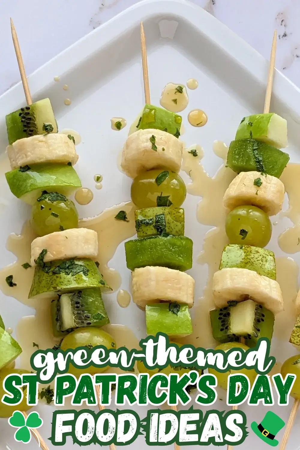 Green Fruit Kabobs - fruit skewers made with chunks of green fruits like kiwi, grapes, green apple, and green pear, plus chunks of bananas, drizzled with a fresh mint, lime juice, and maple sryup sauce.