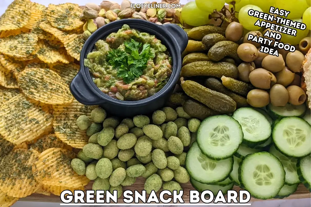 Green Snack Board - Green themed snack board and party tray with homemade garlic bread and guacamole dip, dried chives covered potato chips, fresh cucumbers, mini pickles, olives, pistachios, crunchy wasabi coated peanuts, and green grapes.