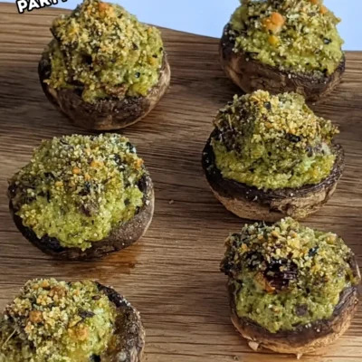 Italian-Style Stuffed Mushrooms With Pesto and Sundried Tomatoes - oven-baked white button mushrooms filled with a creamy ricotta, pesto, cream cheese, and sundried tomato filling topped with dried breadcrumbs.