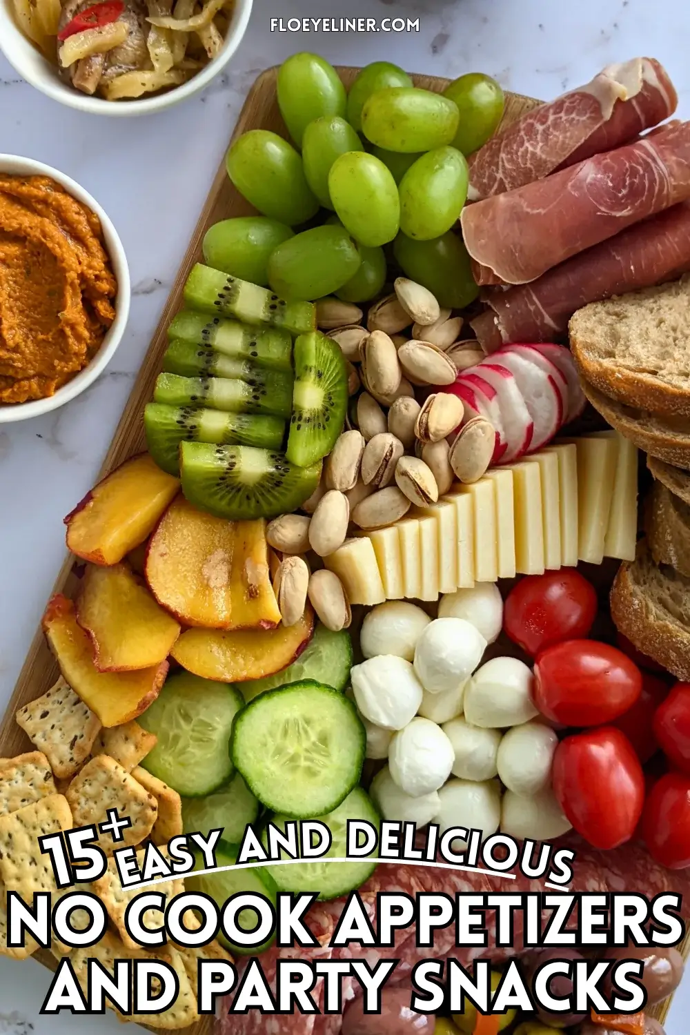 Colorful Antipasto Party Food Platter - A vibrant colorful antipasto party food platter with cured meats, marinated veggies, cheeses, olives, fruit, and ciabatta arranged on a wooden platter.